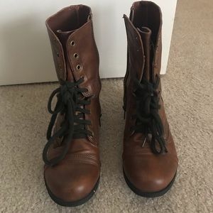 Brown lace up combat boots.